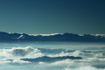 Scenic view of mountains against blue sky