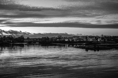 Scenic view of river against sky at dusk