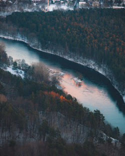 Neris river flowing through vingis park in winter at sunset.