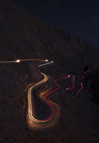 High angle view of light trails on road at night