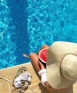 High angle view of woman sitting at poolside