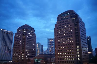 Low angle view of skyscrapers against blue sky