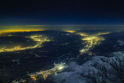 Aerial view of illuminated mountain against sky at night