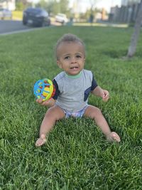 Boy playing with ball on grass