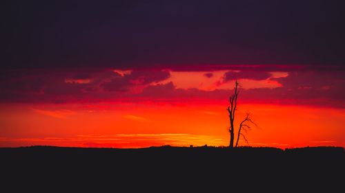 Silhouette landscape against sky during sunset