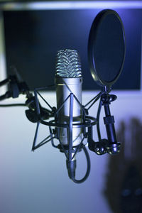 Close-up of microphone against blue background