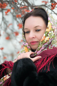 Close-up of woman wearing scarf at park