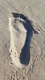 High angle view of footprints on sand