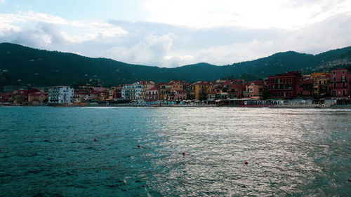 Town by sea against sky