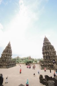 Group of people in temple against sky