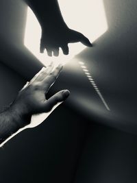 Close-up of hand touching shadow