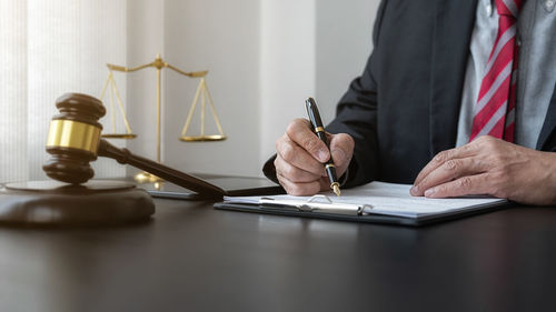 Midsection of man and woman sitting on table