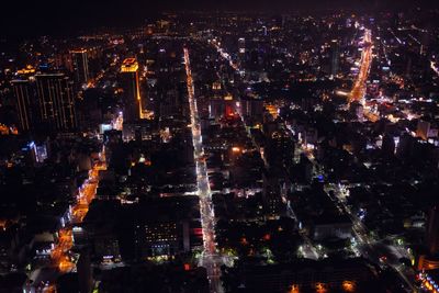 Aerial view of city lit up at night