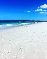 Scenic view of beach against blue sky