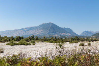 Scenic view of snowcapped mountains against clear sky