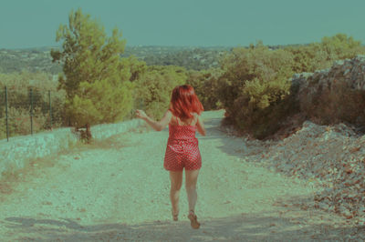 Rear view of woman standing in water