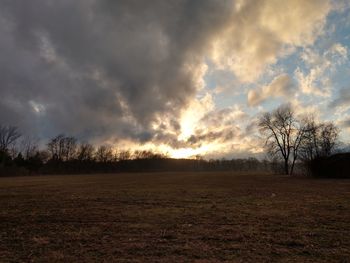 Scenic view of field against sky during sunset