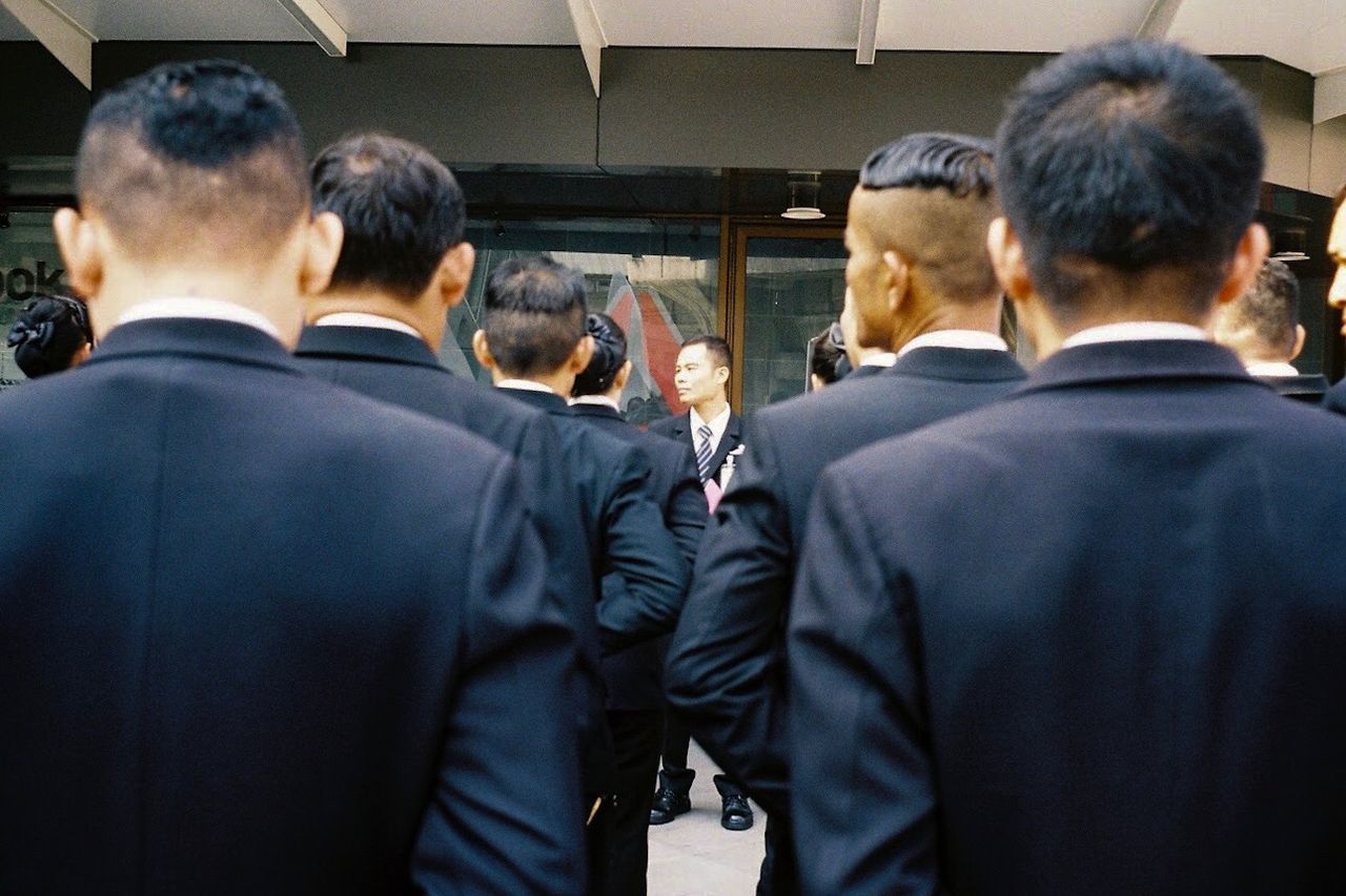 group of people, rear view, men, real people, crowd, adult, large group of people, well-dressed, suit, group, women, business, lifestyles, business person, transportation, togetherness, selective focus, clothing
