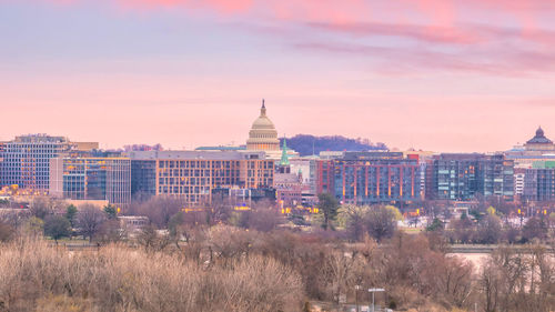 View of buildings in city at sunset