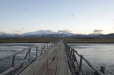 Pier over lake against sky