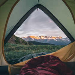 Scenic view of mountain range against sky seen through tent