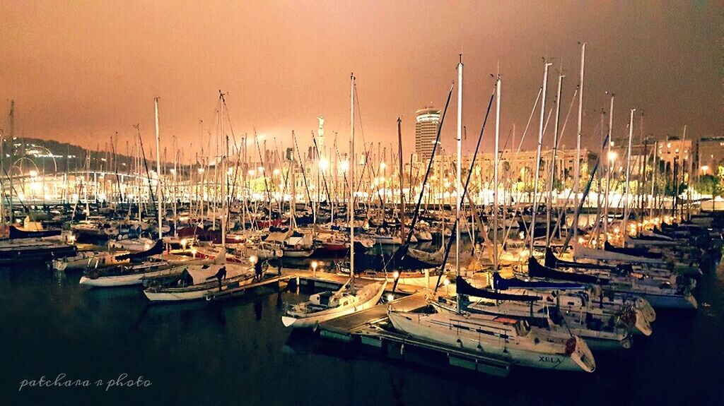 BOATS MOORED IN SEA AT SUNSET