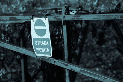 Close-up of information sign on railing