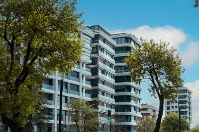 Low angle view of building against sky and trees 