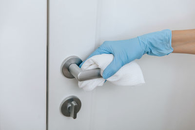 Cropped hand of person cleaning window