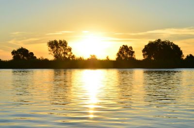 Scenic view of lake at sunset