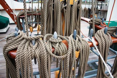 Rope tied to boats moored at harbor