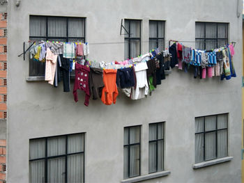 Low angle view of clothes drying outside building