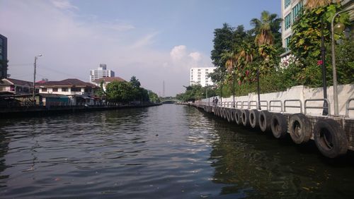 River amidst buildings against sky