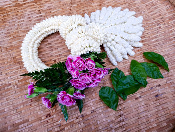 High angle view of pink flowering plant in basket