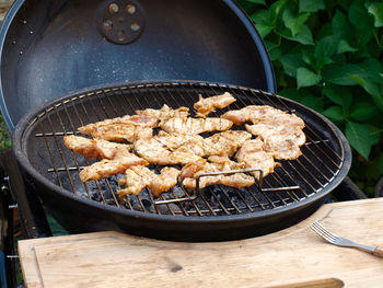 High angle view of meat on barbecue grill