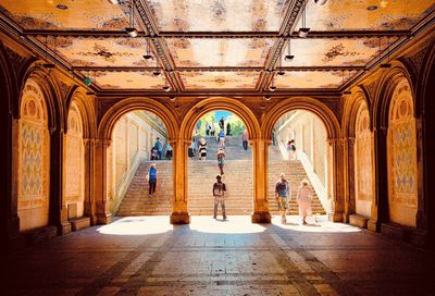 People in corridor of historic building