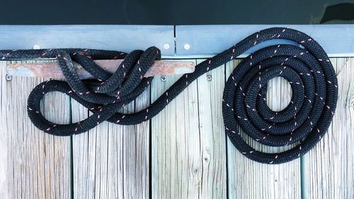 High angle view of rope tied on wood