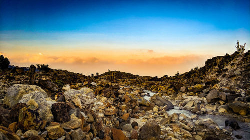 Rock formations against sky during sunset