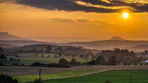 Scenic view of landscape against sky during sunset