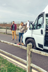 Woman repairing broken down campervan