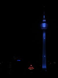 Low angle view of communications tower at night