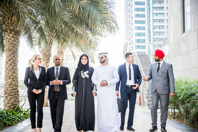 Business people having discussion while walking on street