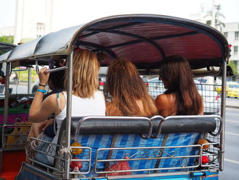 Rear view of women sitting in bus