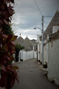 Narrow street amidst buildings against sky