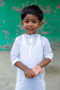 Portrait of smiling boy standing outdoors