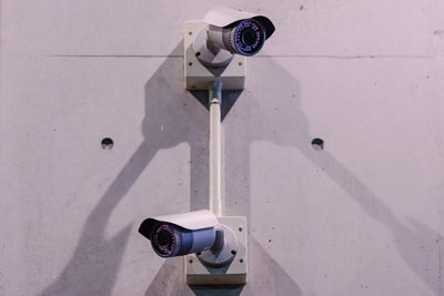 Close-up of security camera against wall