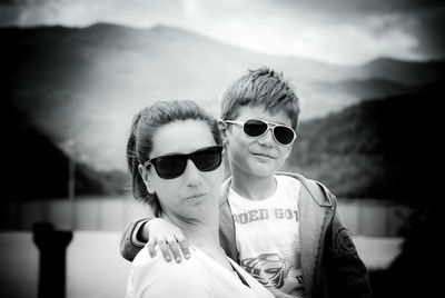 Portrait of woman with smiling son wearing sunglasses