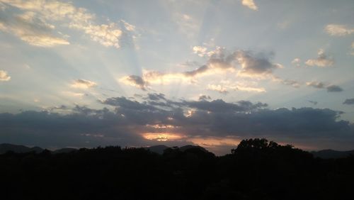 Scenic view of silhouette mountain against dramatic sky