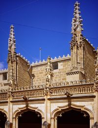 Low angle view of historical building against blue sky