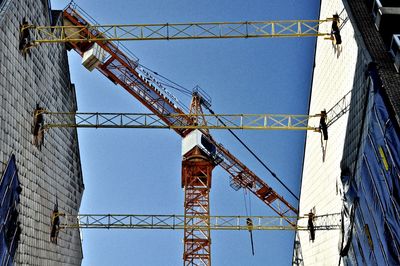 Low angle view of crane against clear sky